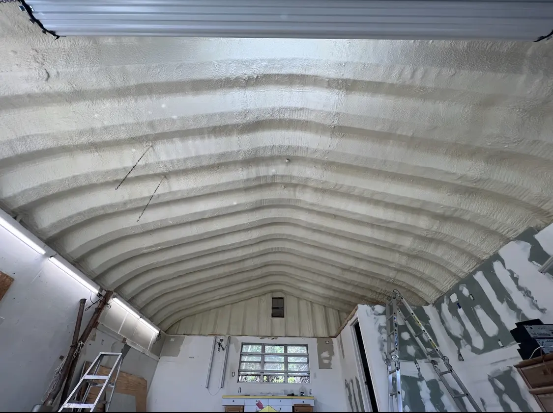 Spray polyurethane foam applied to the underside of a metal roof deck in Woburn